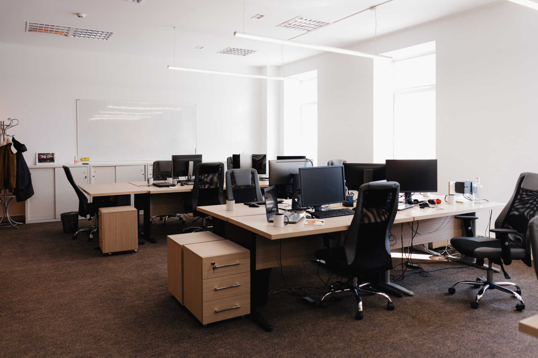 An office room with desks that people work freshly painted with new paint.