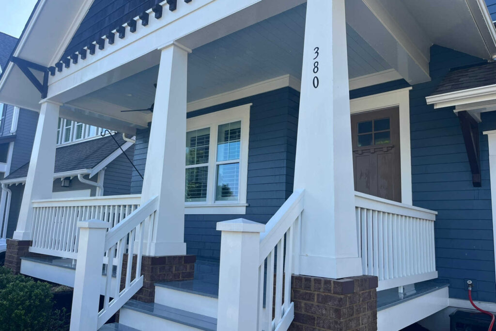 White exterior windows on a residential home painted blue.