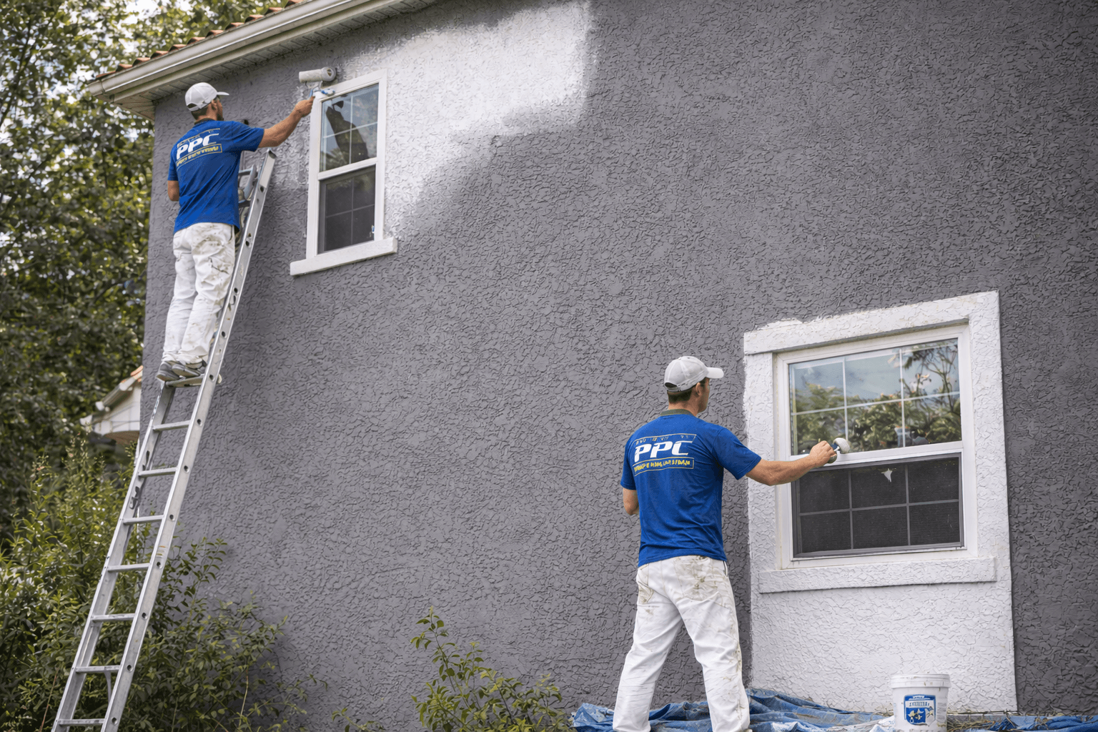 A stucco exterior home getting painted with a new color in Charlotte, NC